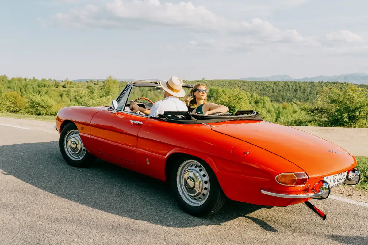 1966 Alfa Romeo Spider Duetto Osso di Seppia driving through Transylvania in Romania